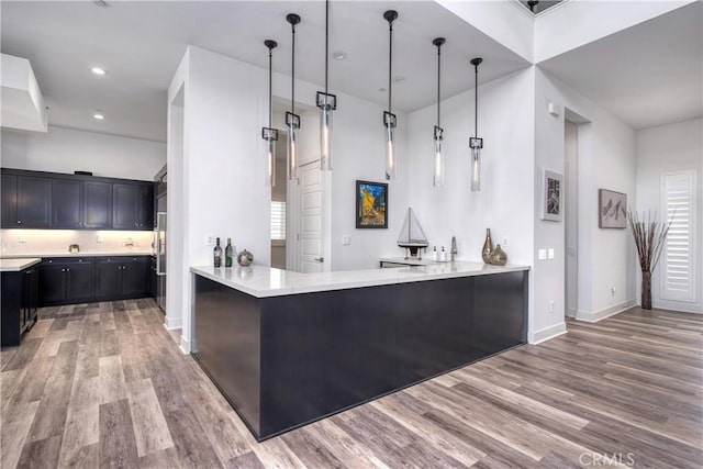 kitchen featuring recessed lighting, light countertops, and light wood finished floors