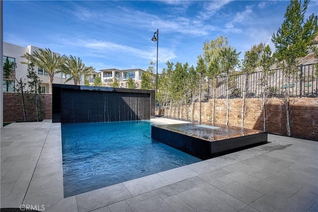 view of swimming pool with a fenced in pool and fence