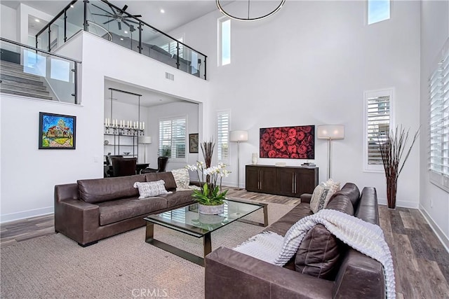 living room featuring wood finished floors, visible vents, and baseboards