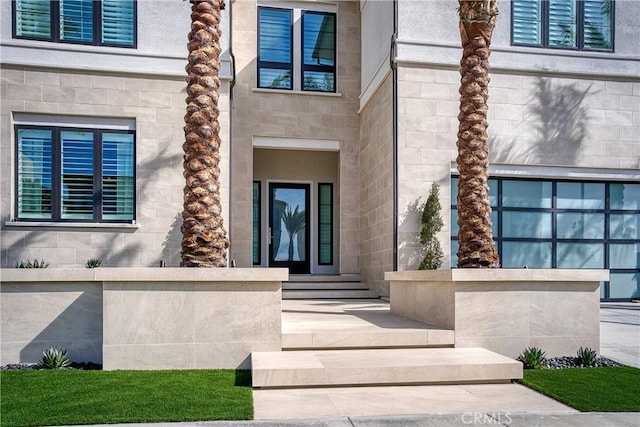 doorway to property with stone siding