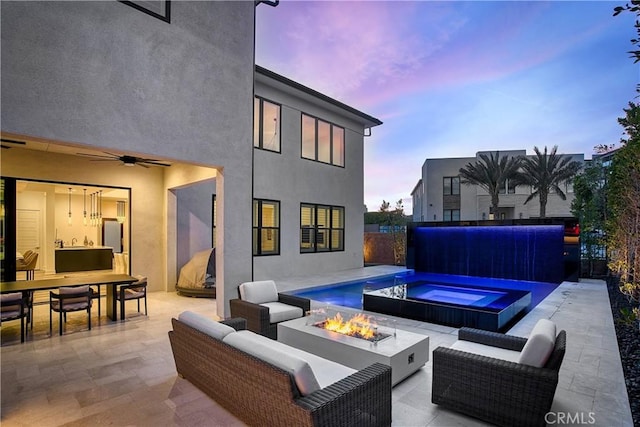 exterior space with ceiling fan, an outdoor pool, and an outdoor living space with a fire pit