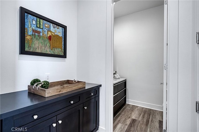 bathroom with baseboards, wood finished floors, and vanity