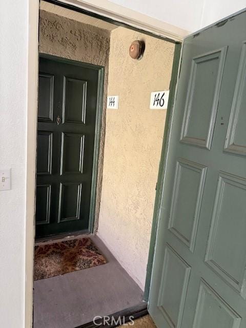 property entrance with stucco siding