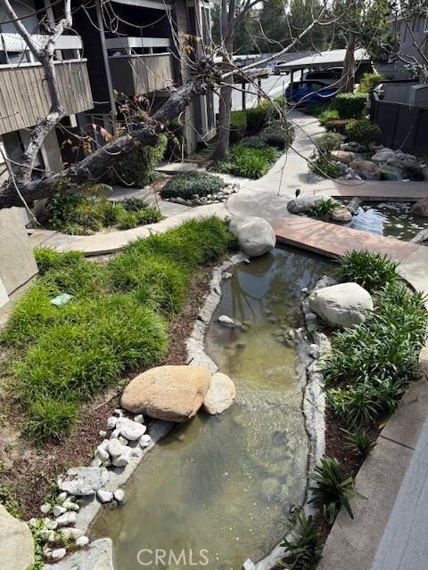 view of yard featuring a small pond