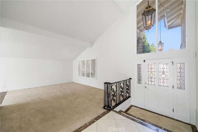 entryway with high vaulted ceiling, carpet flooring, visible vents, beam ceiling, and tile patterned floors