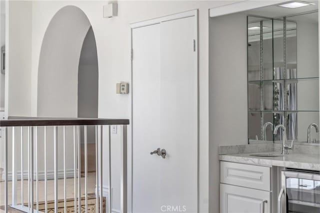 bathroom featuring wine cooler and vanity