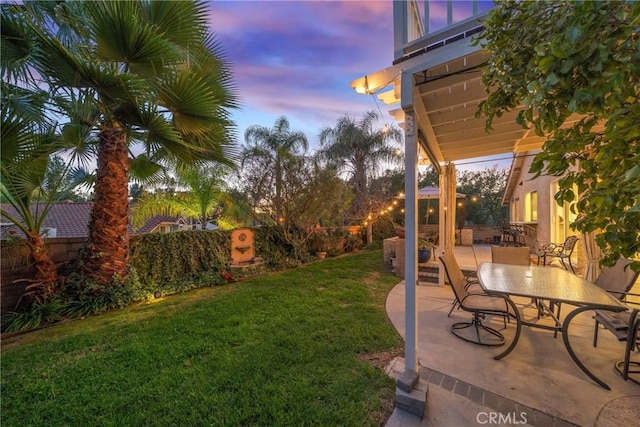 yard at dusk with a patio