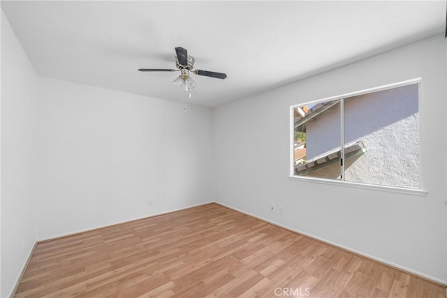 spare room with ceiling fan and wood finished floors