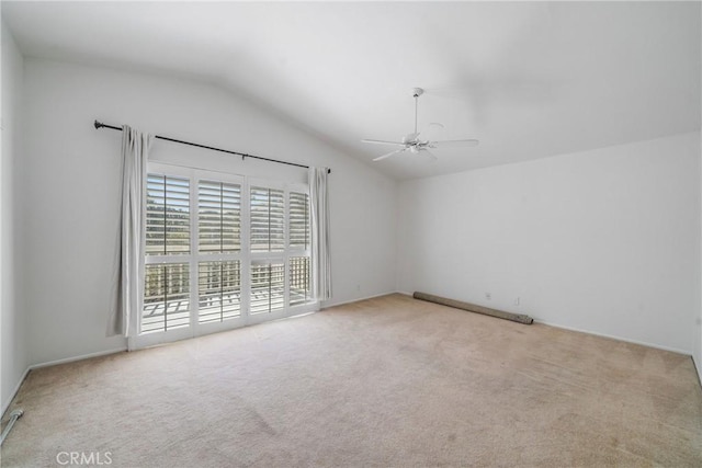 unfurnished room featuring a ceiling fan, carpet flooring, and vaulted ceiling