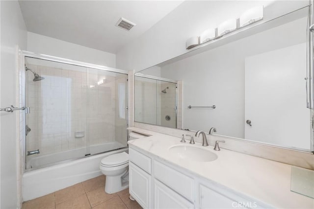 full bath featuring enclosed tub / shower combo, toilet, vanity, visible vents, and tile patterned floors