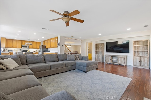 living room featuring visible vents, dark wood finished floors, a ceiling fan, stairway, and recessed lighting