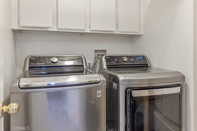 laundry room with cabinet space and washing machine and dryer