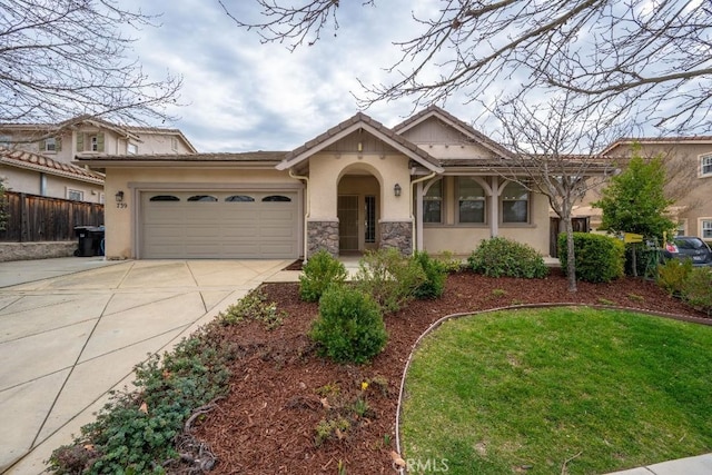 ranch-style home featuring concrete driveway, stone siding, an attached garage, fence, and stucco siding