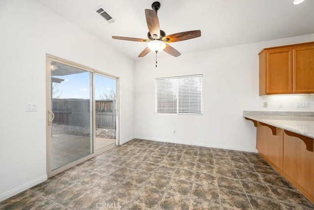 interior space with visible vents, ceiling fan, and baseboards