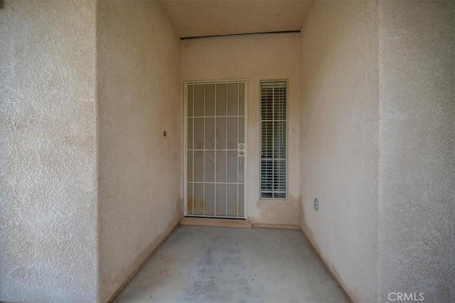 entrance to property with stucco siding