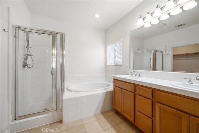 bathroom with a sink, visible vents, a bath, double vanity, and a stall shower