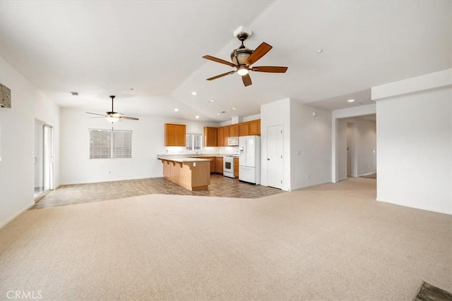 unfurnished living room with lofted ceiling, ceiling fan, recessed lighting, and light colored carpet