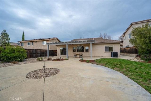 rear view of house with a patio area, a fenced backyard, central AC unit, and a pergola