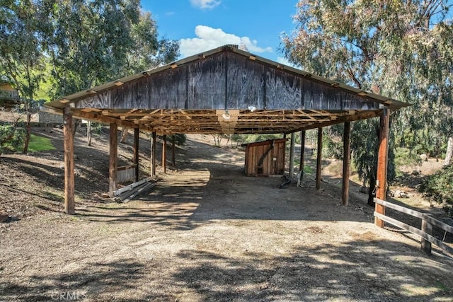 view of home's community with a carport, an outbuilding, and driveway