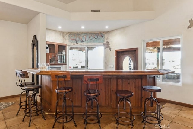 bar with visible vents, baseboards, bar area, and recessed lighting