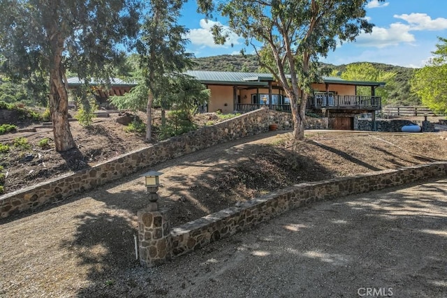 view of front of property with stairway and metal roof