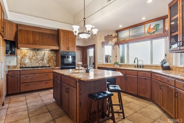 kitchen with lofted ceiling, black appliances, a healthy amount of sunlight, and backsplash