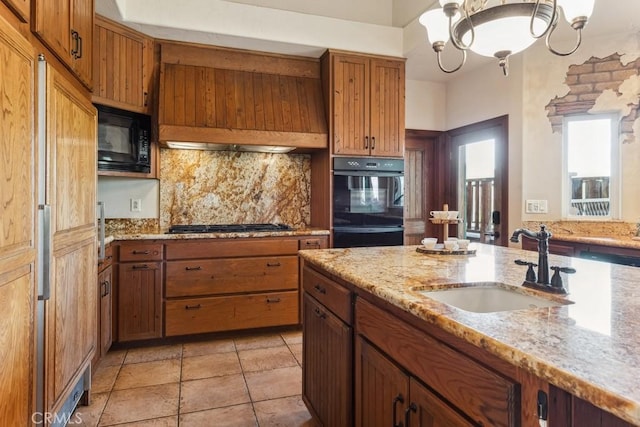 kitchen with black appliances, decorative backsplash, brown cabinetry, and a sink