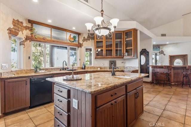 kitchen featuring lofted ceiling, a sink, light stone countertops, dishwasher, and glass insert cabinets