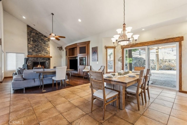 dining room featuring recessed lighting, ceiling fan with notable chandelier, a fireplace, high vaulted ceiling, and light tile patterned flooring