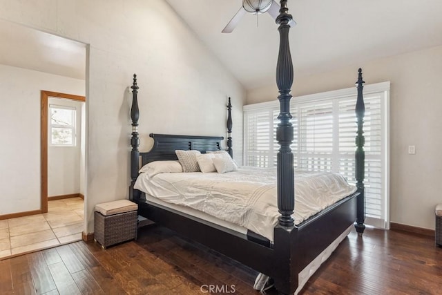 bedroom featuring ceiling fan, wood-type flooring, baseboards, and vaulted ceiling