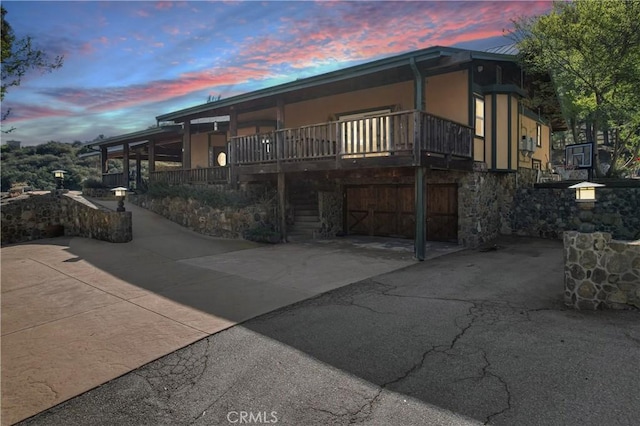 view of front of property featuring driveway, a garage, and stucco siding