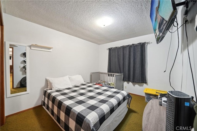 carpeted bedroom featuring a textured ceiling and baseboards