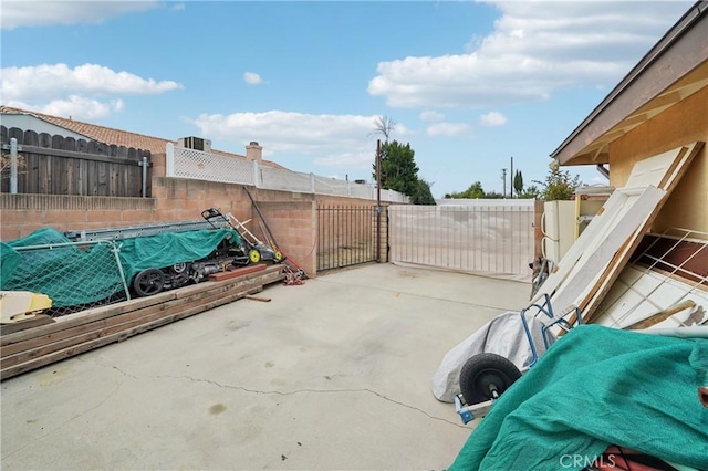 view of patio featuring a gate and fence