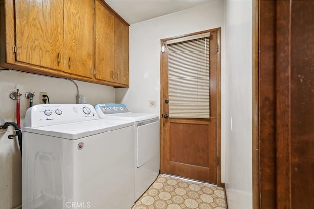 laundry area featuring cabinet space, light floors, and independent washer and dryer