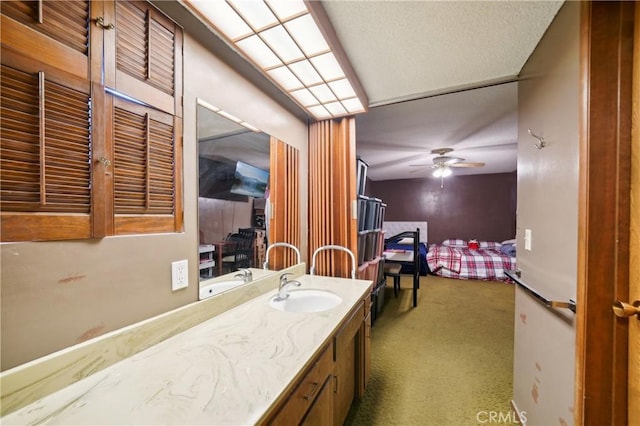 bathroom with ceiling fan and vanity