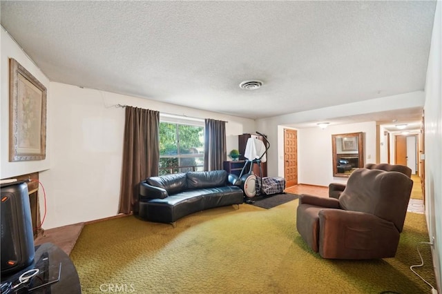 living room featuring a textured ceiling, carpet, and visible vents