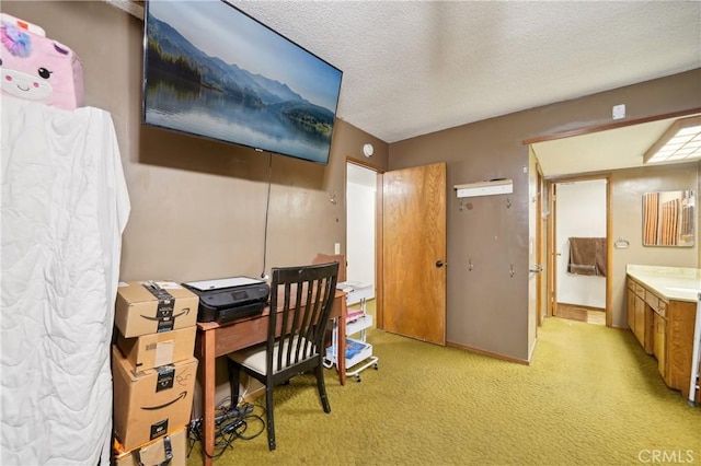 office space with light carpet, baseboards, and a textured ceiling