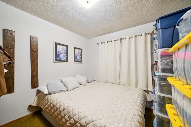 bedroom featuring a textured ceiling and baseboards