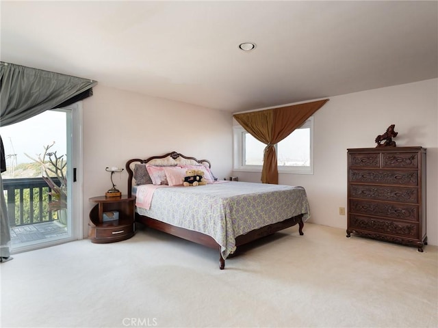 carpeted bedroom with access to outside