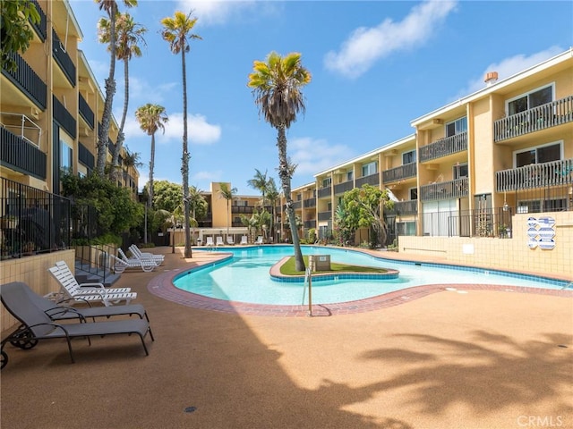 pool featuring a patio and fence