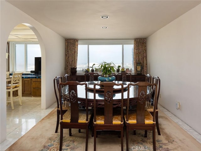 dining room with arched walkways