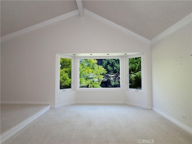 carpeted spare room featuring vaulted ceiling with beams and baseboards