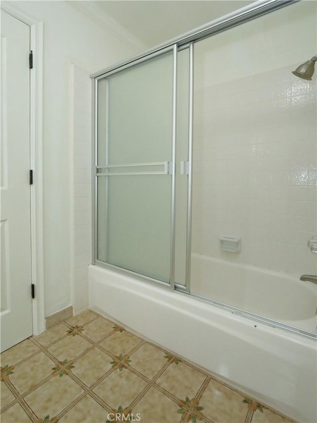 full bath with shower / bath combination with glass door and tile patterned flooring