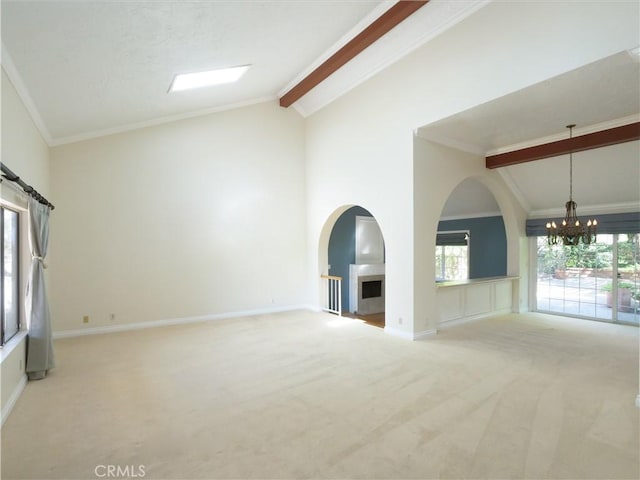 unfurnished living room with a notable chandelier, carpet floors, beamed ceiling, and crown molding