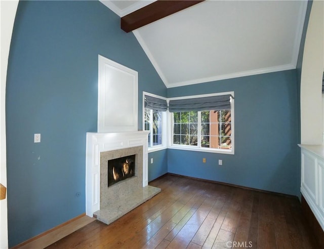 unfurnished living room with vaulted ceiling with beams, wood-type flooring, crown molding, and a fireplace