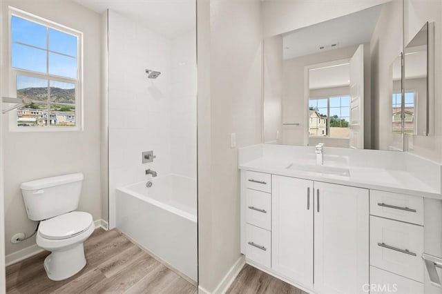 full bathroom with toilet, baseboards, wood finished floors, and vanity