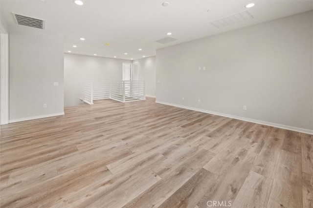 spare room featuring baseboards, recessed lighting, visible vents, and light wood-style floors