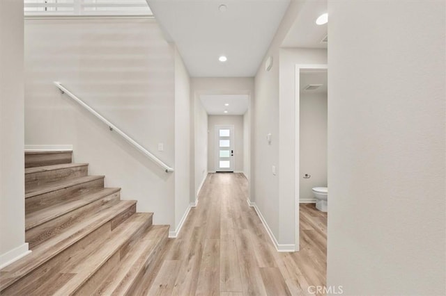 interior space with recessed lighting, stairway, baseboards, and wood finished floors