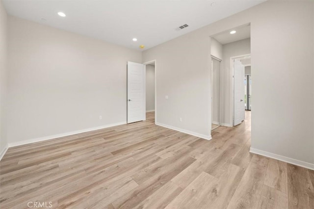 unfurnished room featuring baseboards, recessed lighting, visible vents, and light wood-style floors