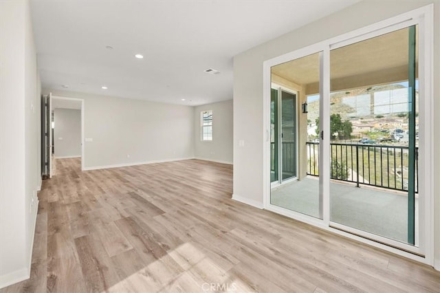 unfurnished room featuring light wood-style flooring, visible vents, baseboards, and recessed lighting